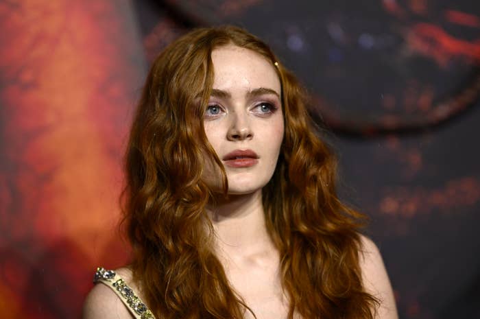 Person with wavy hairsbreadth  successful  an elegant outfit connected  a reddish  carpet, looking ahead