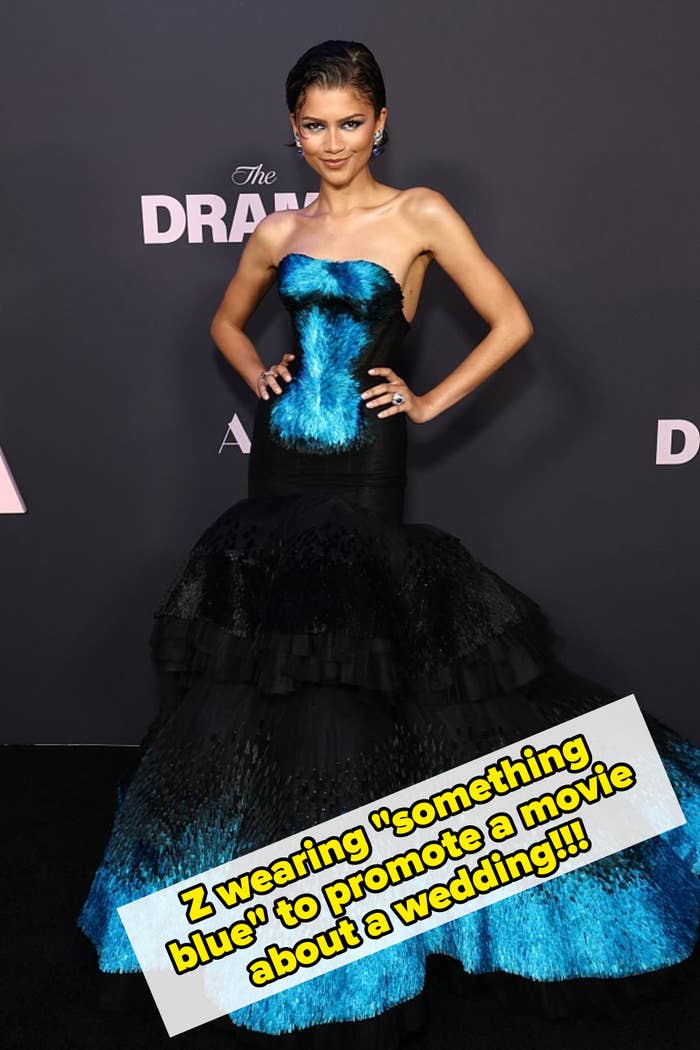 Person successful  strapless gown with flared skirt connected  reddish  carpet, posing confidently