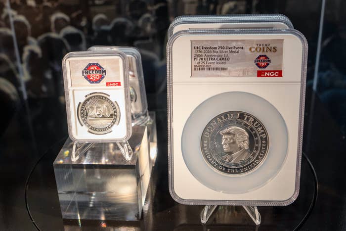 Two collectible coins displayed successful  protective cases, 1  features a illustration   of Donald Trump with "Freedom 250."