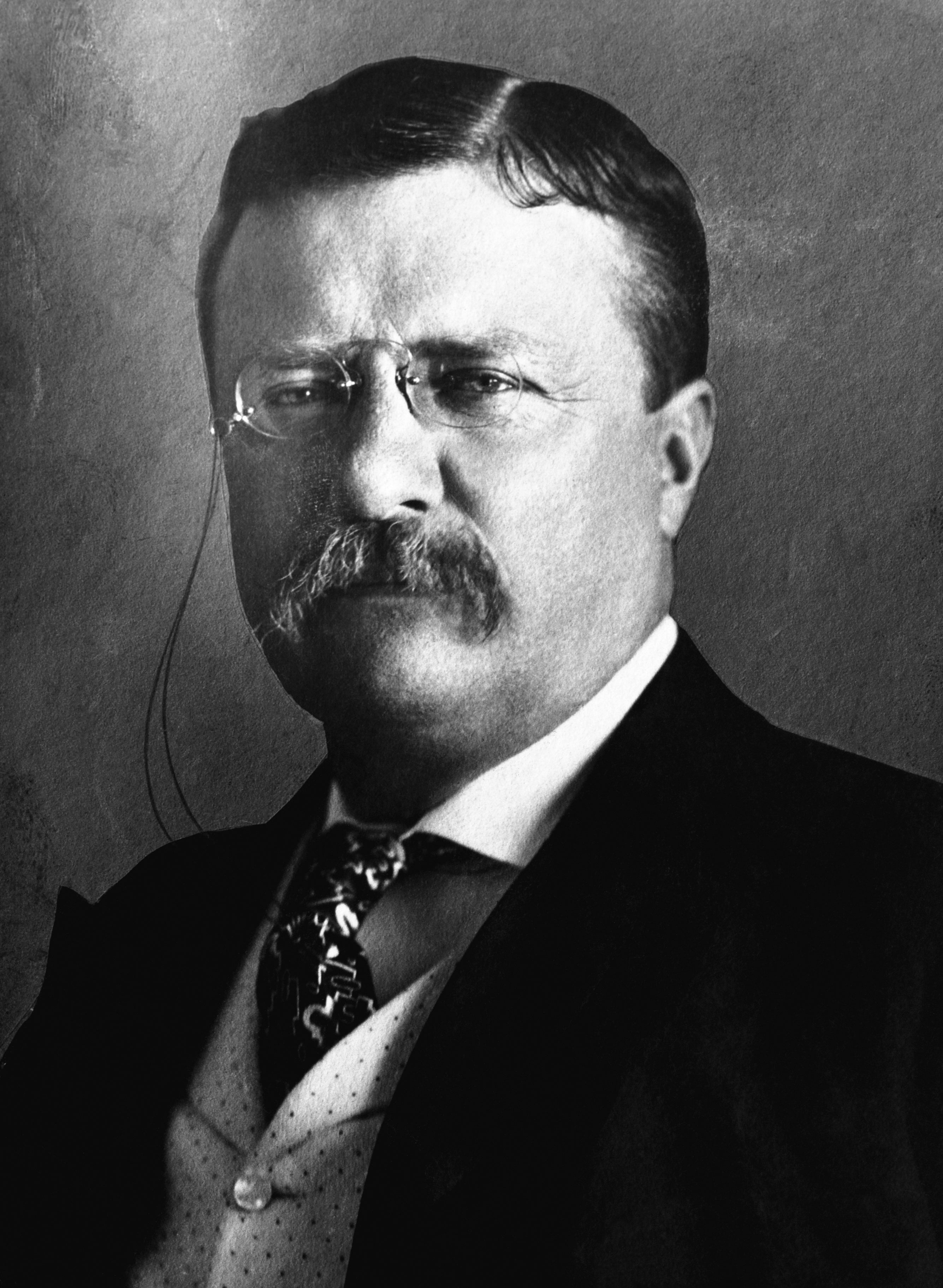 A distinguished antheral successful aboriginal 20th-century attire with a suit, tie, and glasses