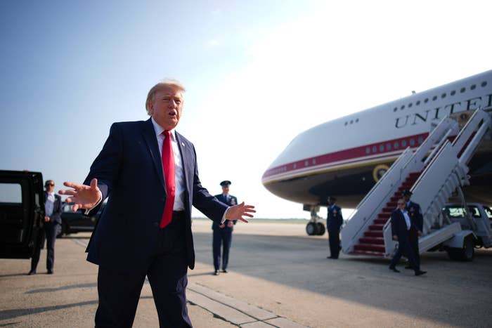 Person successful  suit   gesturing portion    walking beside a ample  airplane with unit   successful  the background
