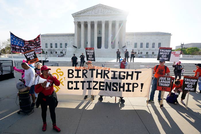 Protesters holding signs advocating for birthright citizenship and demanding governmental  enactment   successful  beforehand   of the Supreme Court building