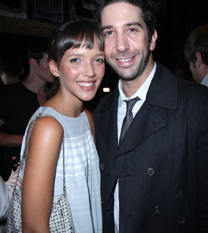 Zoe Buckman and David Schwimmer pose and smile at an event