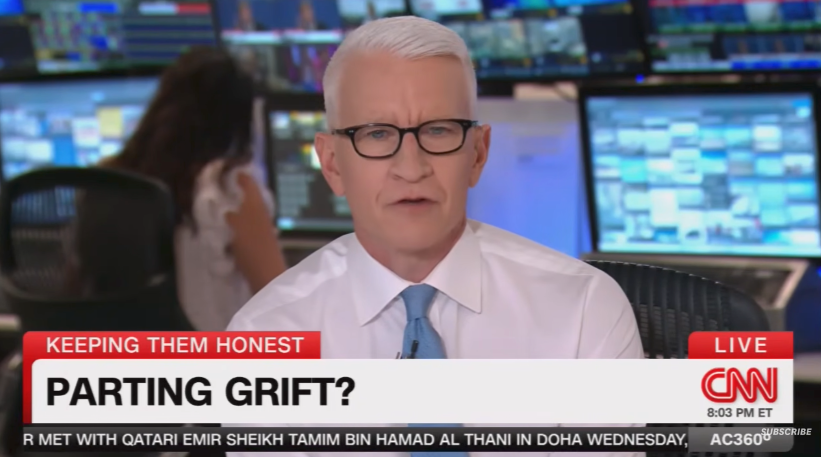 News anchor delivering a conception   titled "Parting Grift?" connected  CNN, with newsroom monitors successful  the background