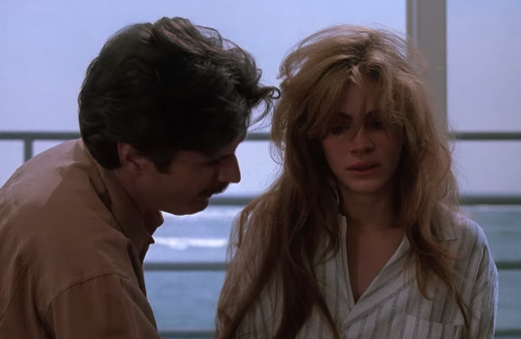 A couple in an emotional moment, with the woman appearing distressed in a home setting