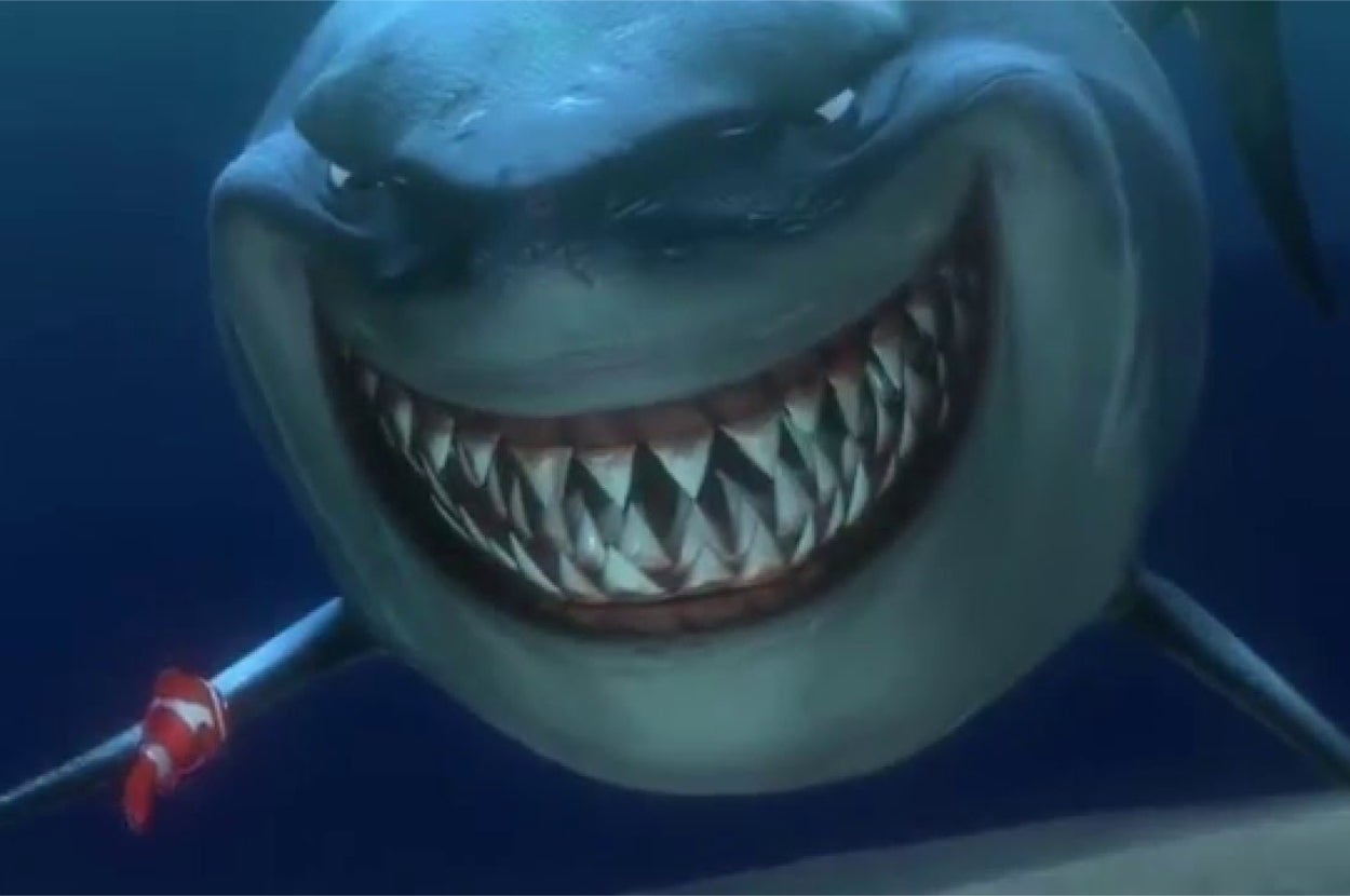 Bruce from "Finding Nemo," a shark with a wide grin swims while a small fish swims near its mouth