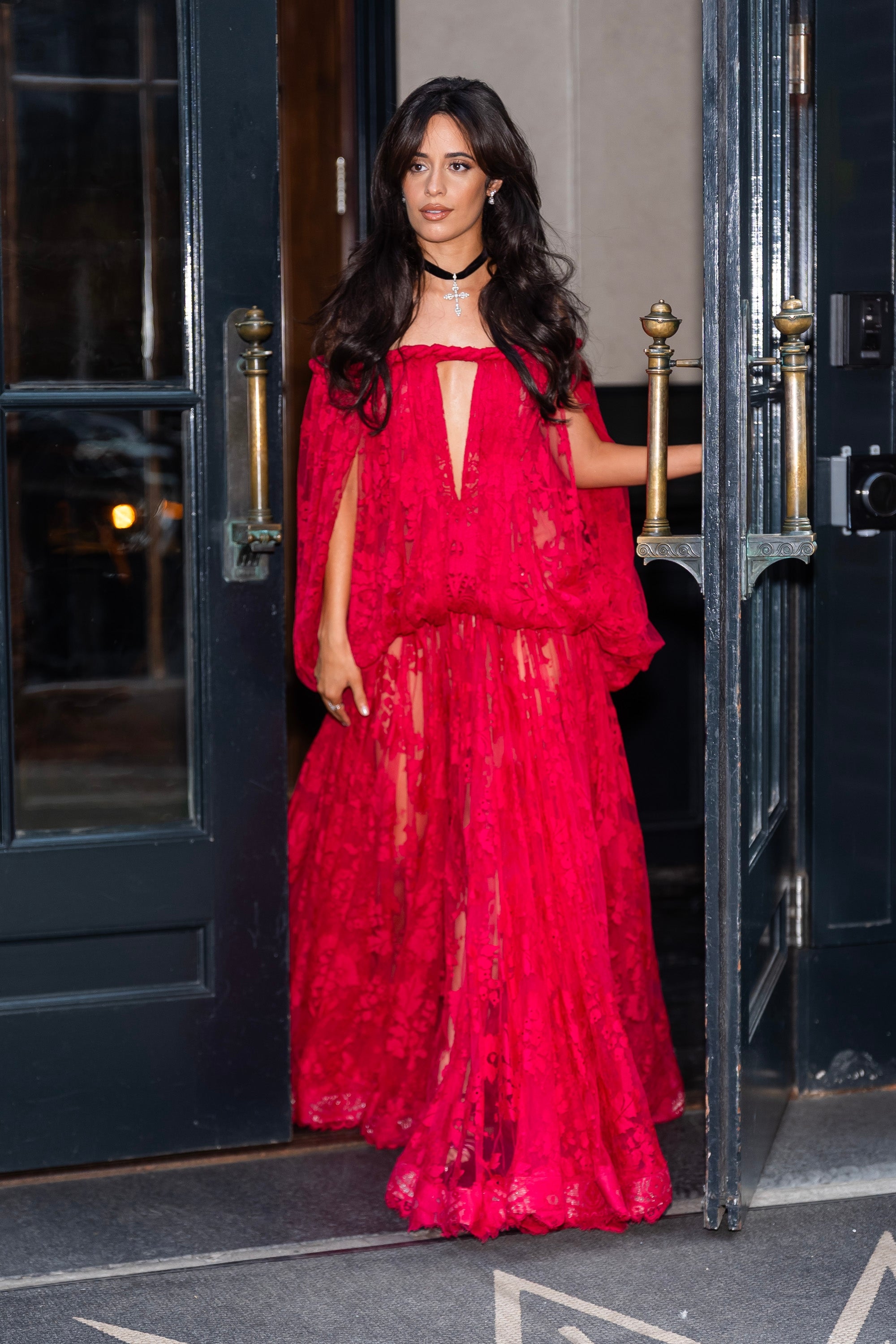 Camila Cabello steps retired  successful  a flowing lace gown with a cape design, accessorized with a connection    necklace
