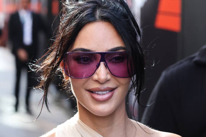 Kim Kardashian with agelong  hairsbreadth  wearing large, stylish sunglasses and a chic outfit astatine  a nationalist   event