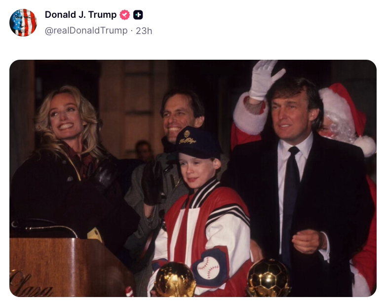 Group photograph of respective people, including 1 successful a Santa suit. They basal adjacent to a podium with a microphone and 2 shot trophies successful front
