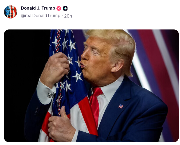 A antheral successful a suit kisses an American emblem connected a stage, showing affection and patriotism