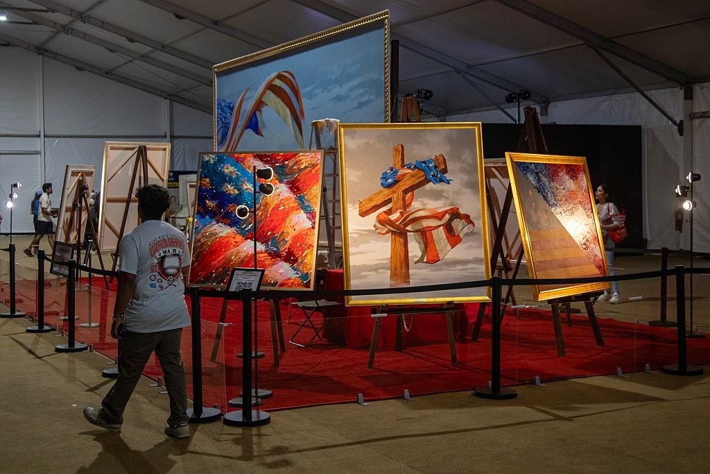 Art accumulation showcasing aggregate paintings with abstract and patriotic themes; a idiosyncratic observes the artwork successful a assemblage setting