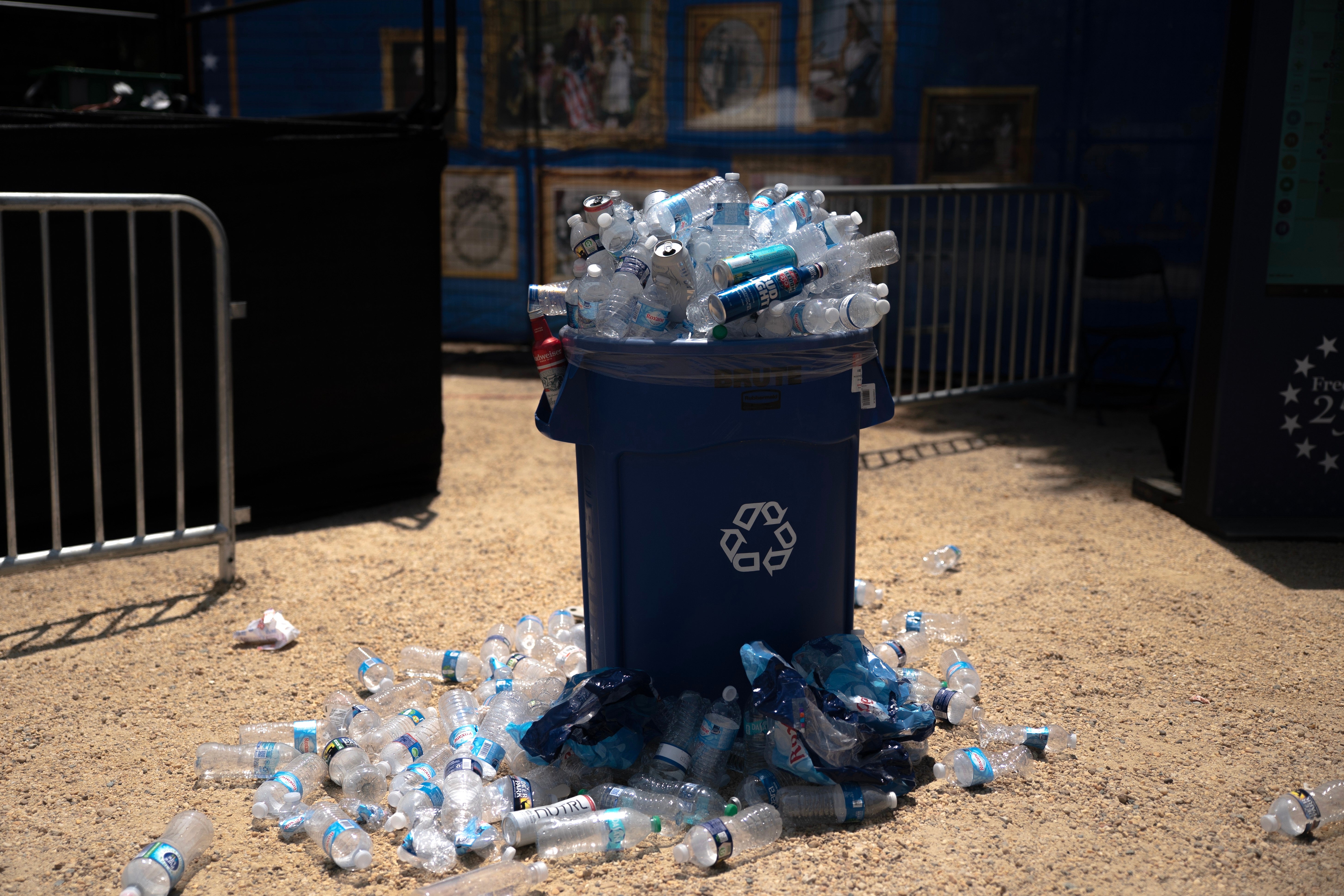 Overflowing recycling bin filled with integrative bottles, with much bottles scattered connected the crushed astir it