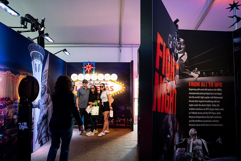 People posing for a photograph adjacent a Las Vegas motion astatine an grounds featuring boxing and UFC past displays