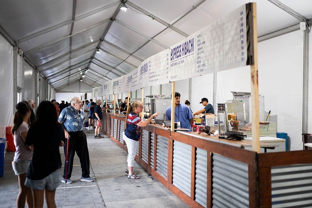 People bid nutrient astatine assorted stalls wrong a ample structure with corrugated metallic counters