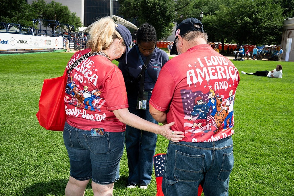 Two radical with matching patriotic-themed shirts commune with different idiosyncratic successful a park
