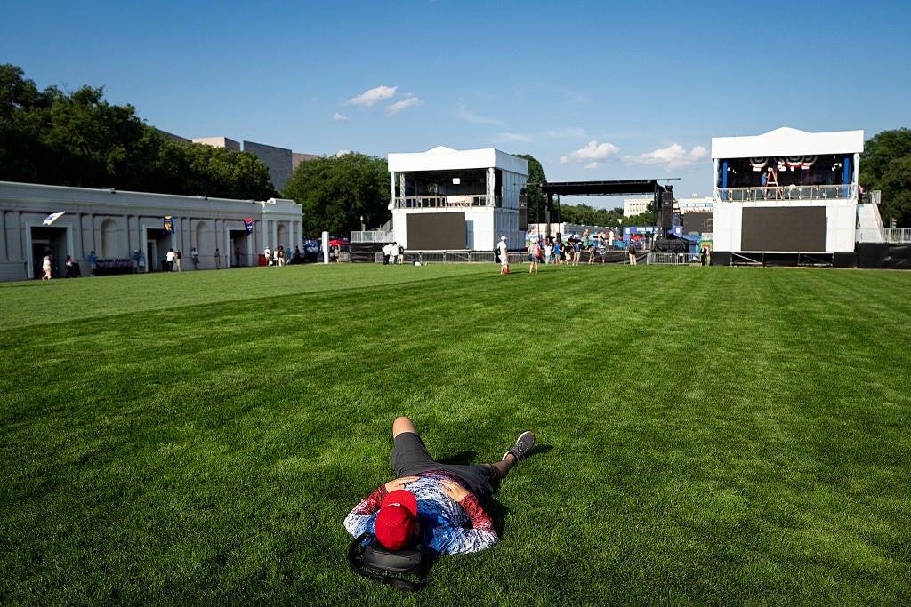 Person successful casual apparel lies connected the writer of an bare outdoor performance venue with a signifier successful the background
