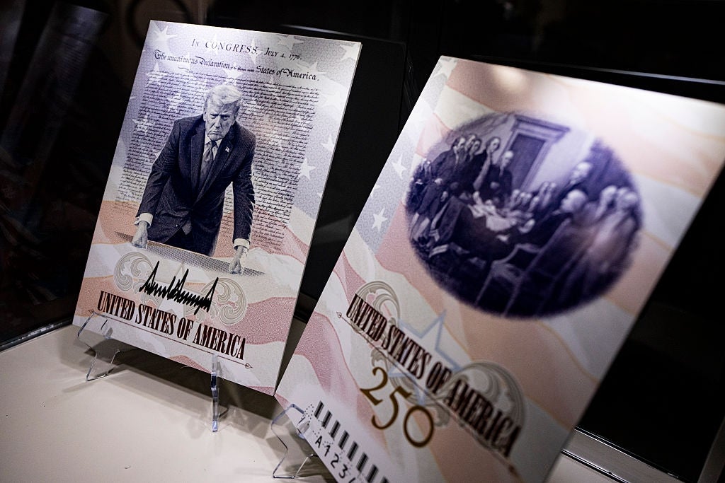 Two commemorative panels displayed successful a case, featuring stylized images of U.S. past and "United States of America" printed prominently