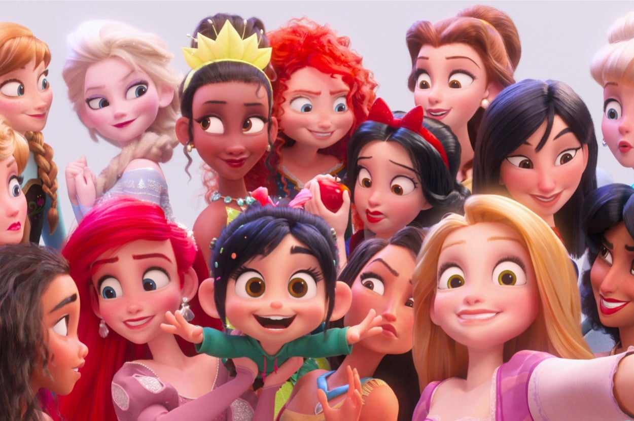 Animated characters posing together, featuring various princesses with distinctive styles and a central character energetically gesturing for a selfie