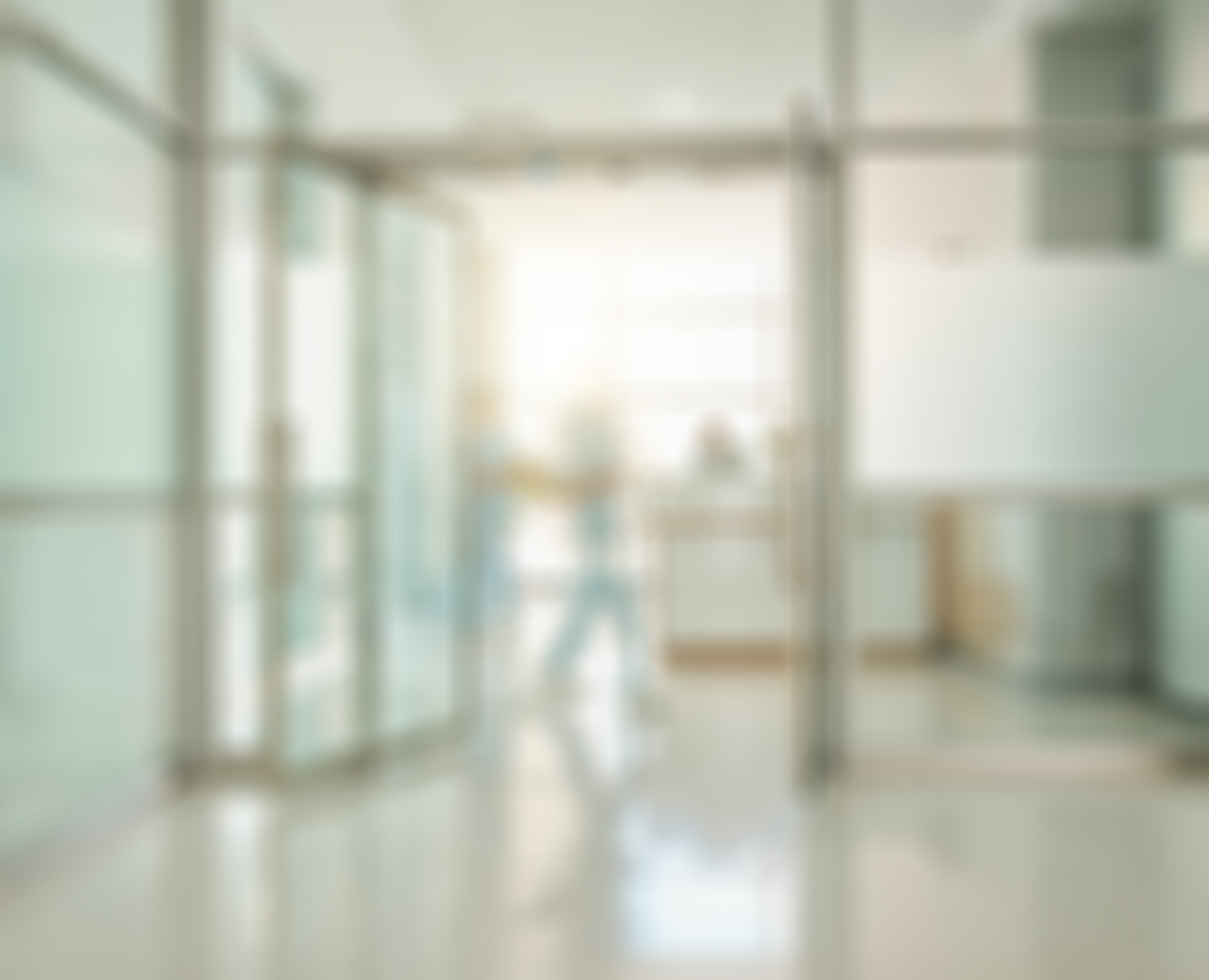 Blurry representation  of a idiosyncratic   walking done  solid  doors successful  a bright, modern   bureau   setting