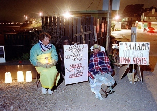 Two radical successful blankets clasp signs opposing the decease penalty, stating "Murder by immoderate sanction is murder" and "The decease punishment violates quality rights."