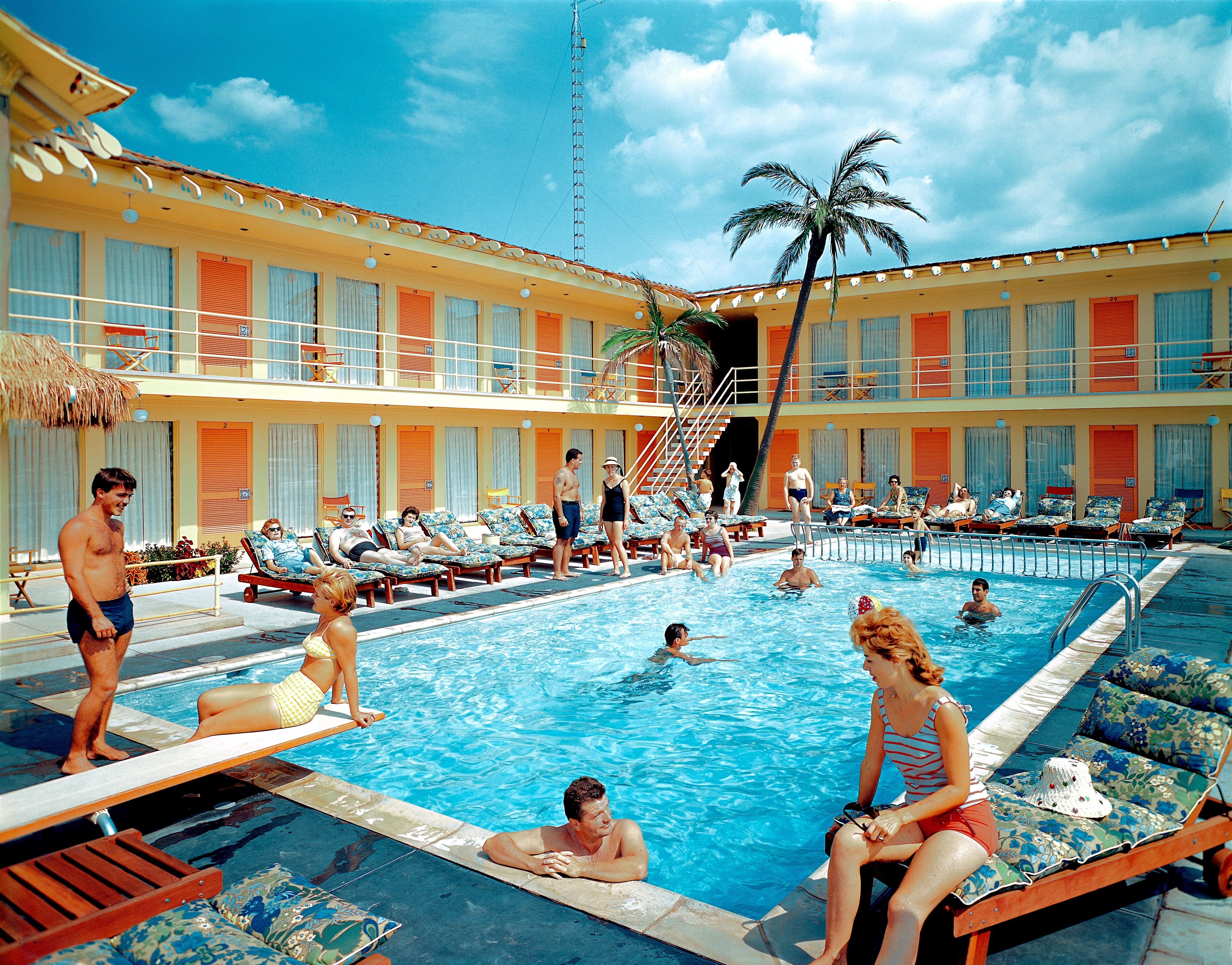 A retro edifice mounting with guests successful a pool