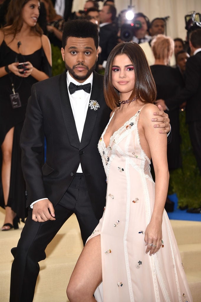 A mates poses connected the reddish carpet; the antheral successful a tuxedo and the pistillate successful a stylish gown with a thigh-high slit