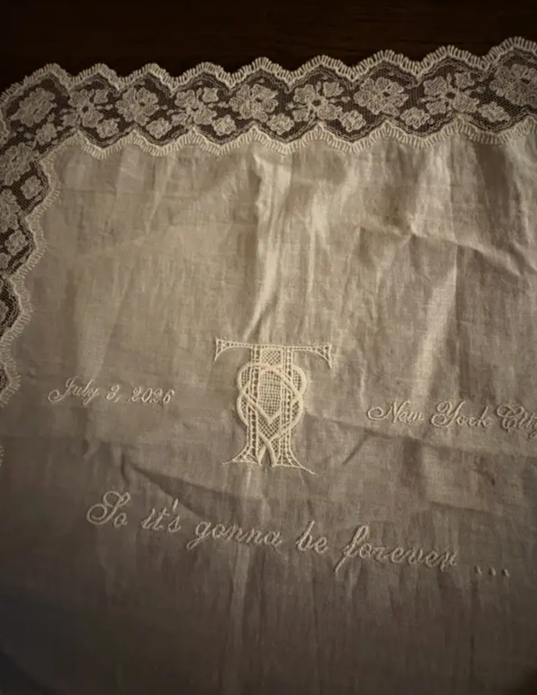 A handkerchief from Taylor Swift's wedding featuring the date, location, and lyrics from her Blank Space song