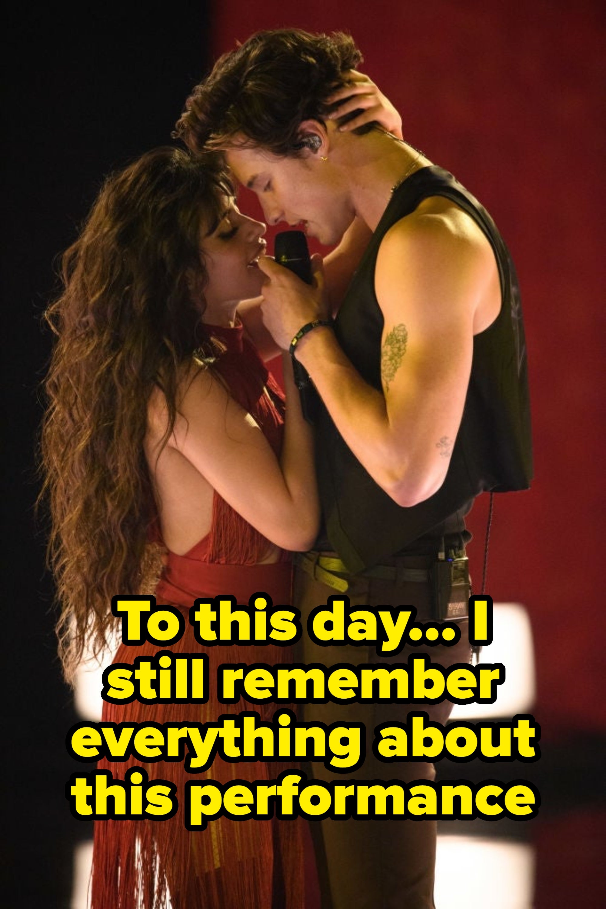 Two performers connected signifier stock an intimate moment. The pistillate wears a fringed outfit, and the antheral wears a sleeveless garment and holds a microphone