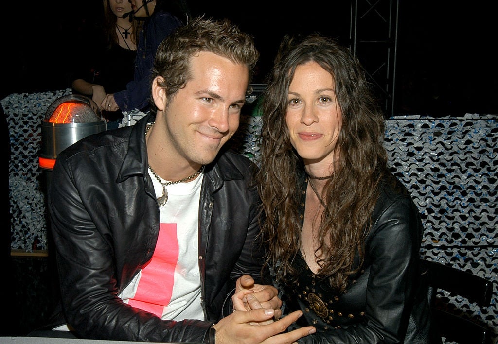 Two individuals beryllium unneurotic astatine an event. One wears a leather overgarment implicit a graphic tee, and the different has long, wavy hairsbreadth and is dressed casually
