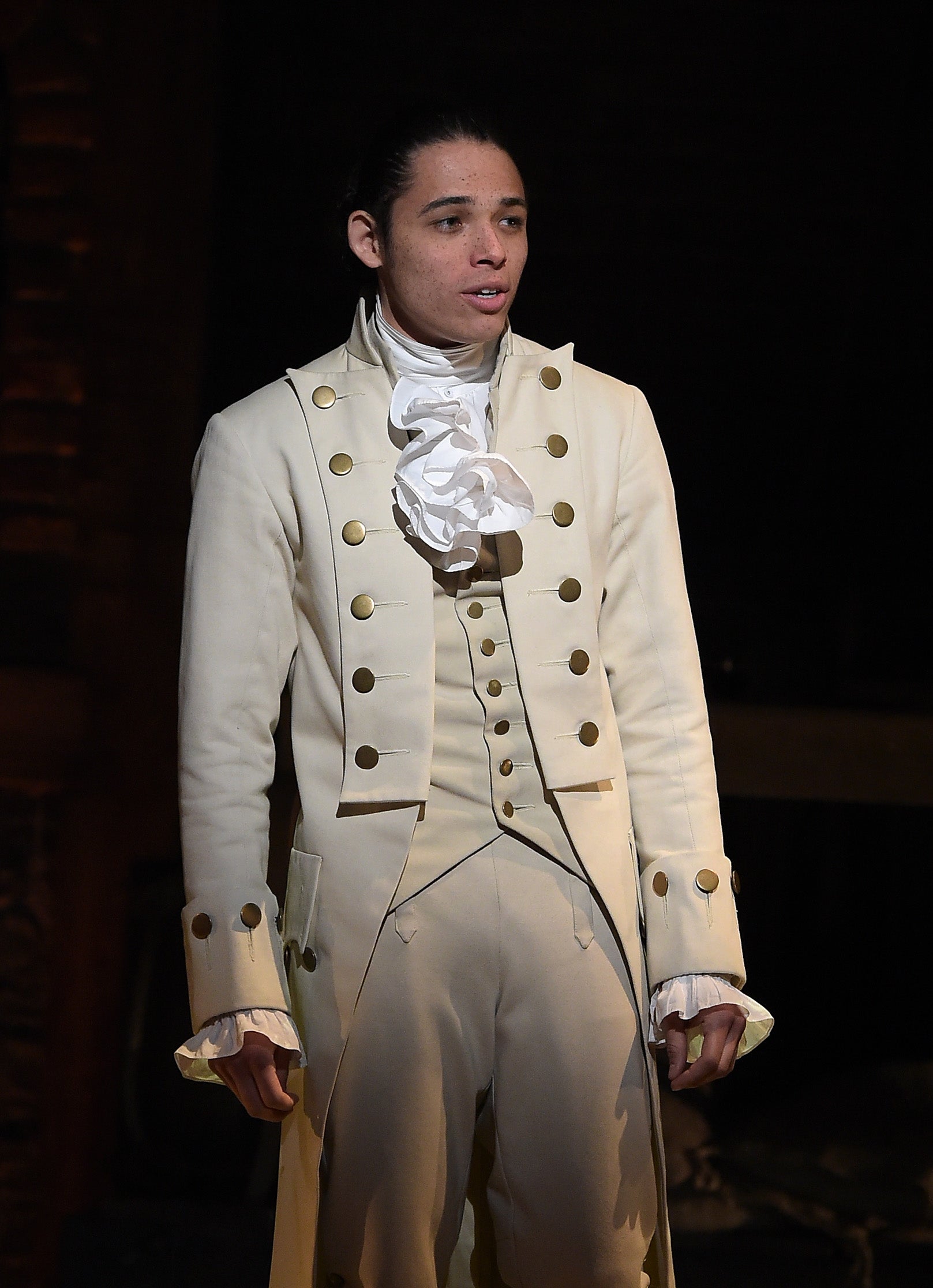 Anthony Ramos performs on Broadway wearing a military-style costume with a high collar and decorative buttons