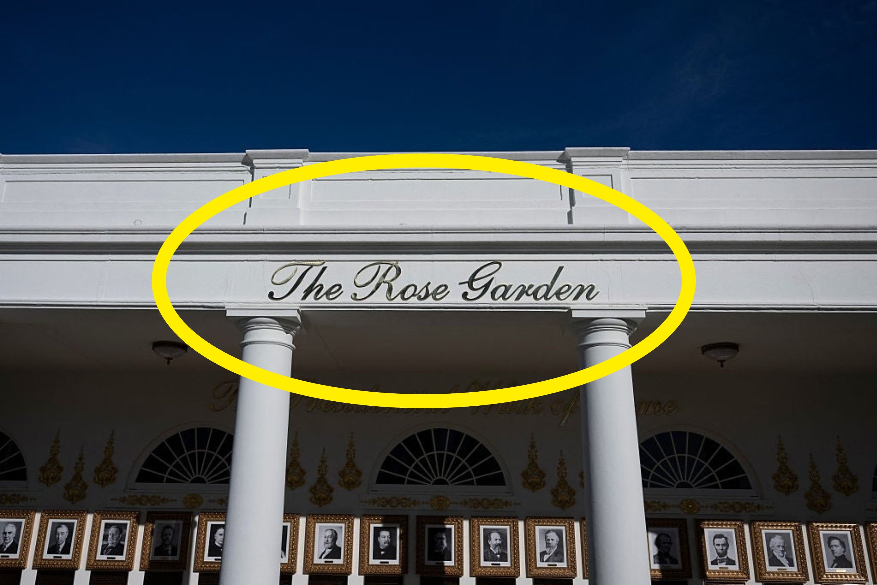 Bagian depan gedung The Rose Garden dengan potret berbingkai dipajang di bawah tanda