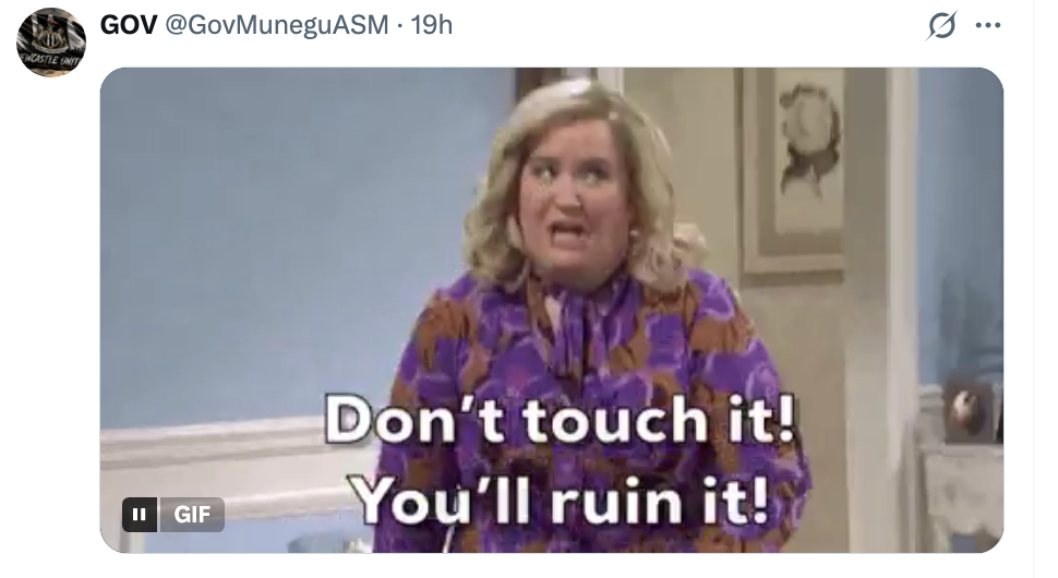 Woman in a patterned dress exclaims, "Don't touch it! You'll ruin it!" in a comedic TV scene