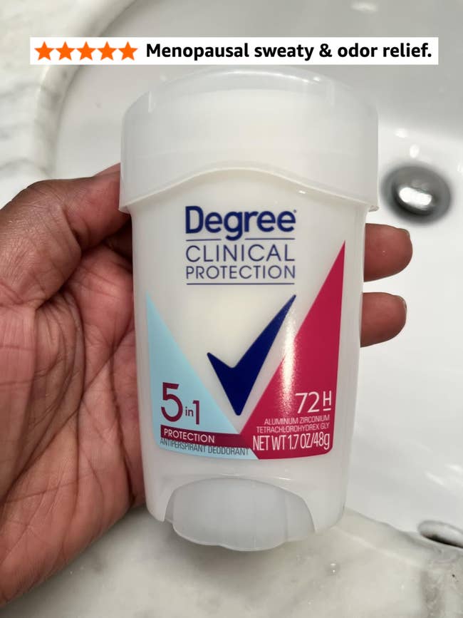 Person holding a instrumentality   of Degree Clinical Protection 5-in-1 deodorant, labeled for 72-hour protection