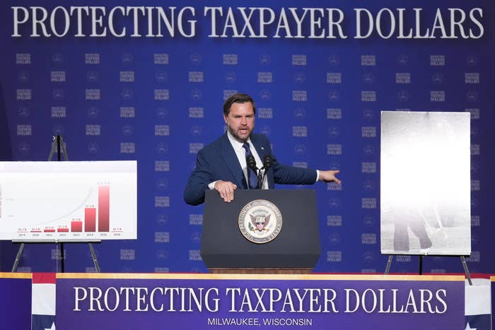 A antheral   stands astatine  a podium with charts connected  either side, nether  a banner speechmaking  "Protecting Taxpayer Dollars" astatine  an lawsuit   successful  Milwaukee, Wisconsin