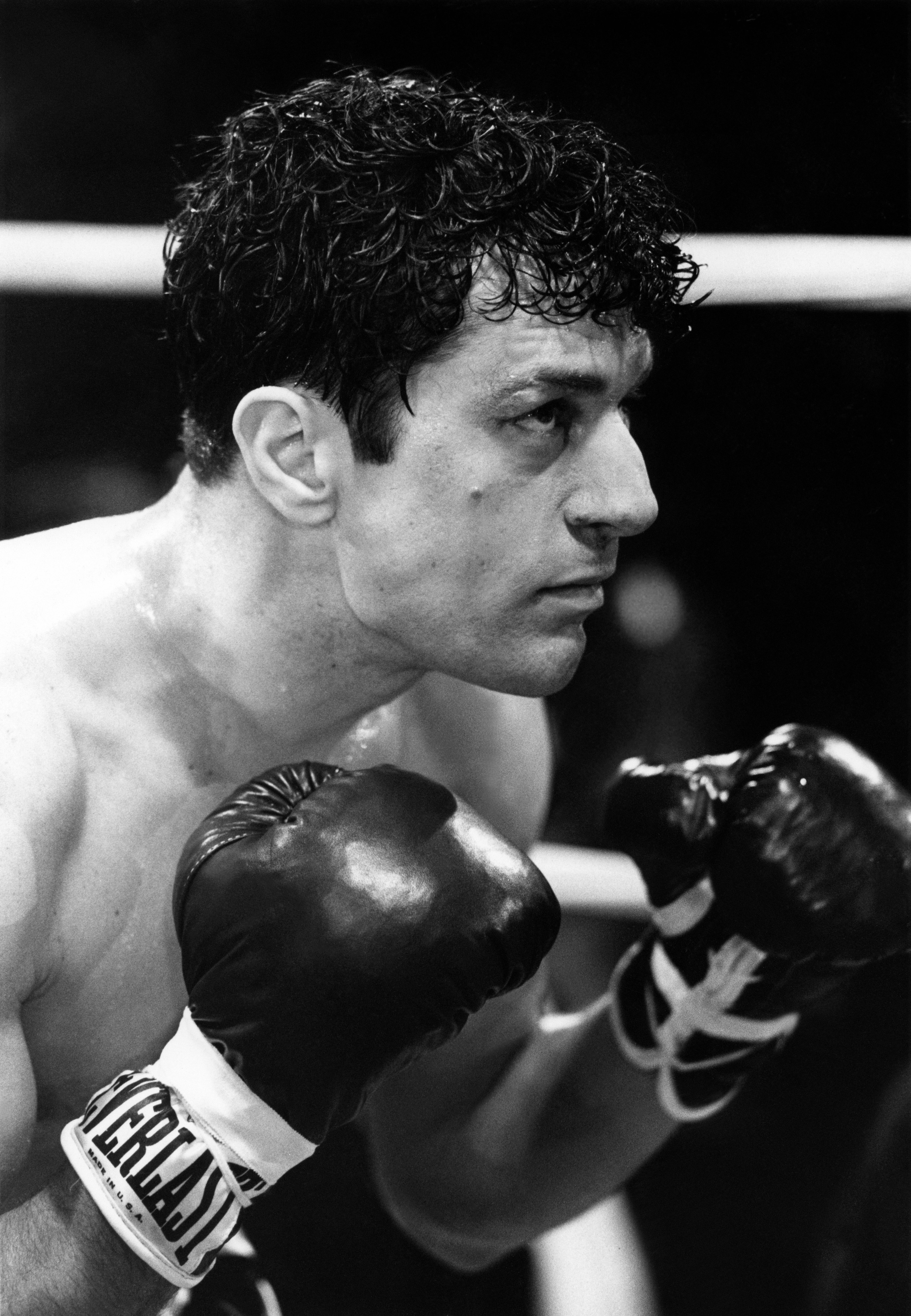 Robert De Niro portrays the boxer Jake LaMotta in a fighting stance with gloves on