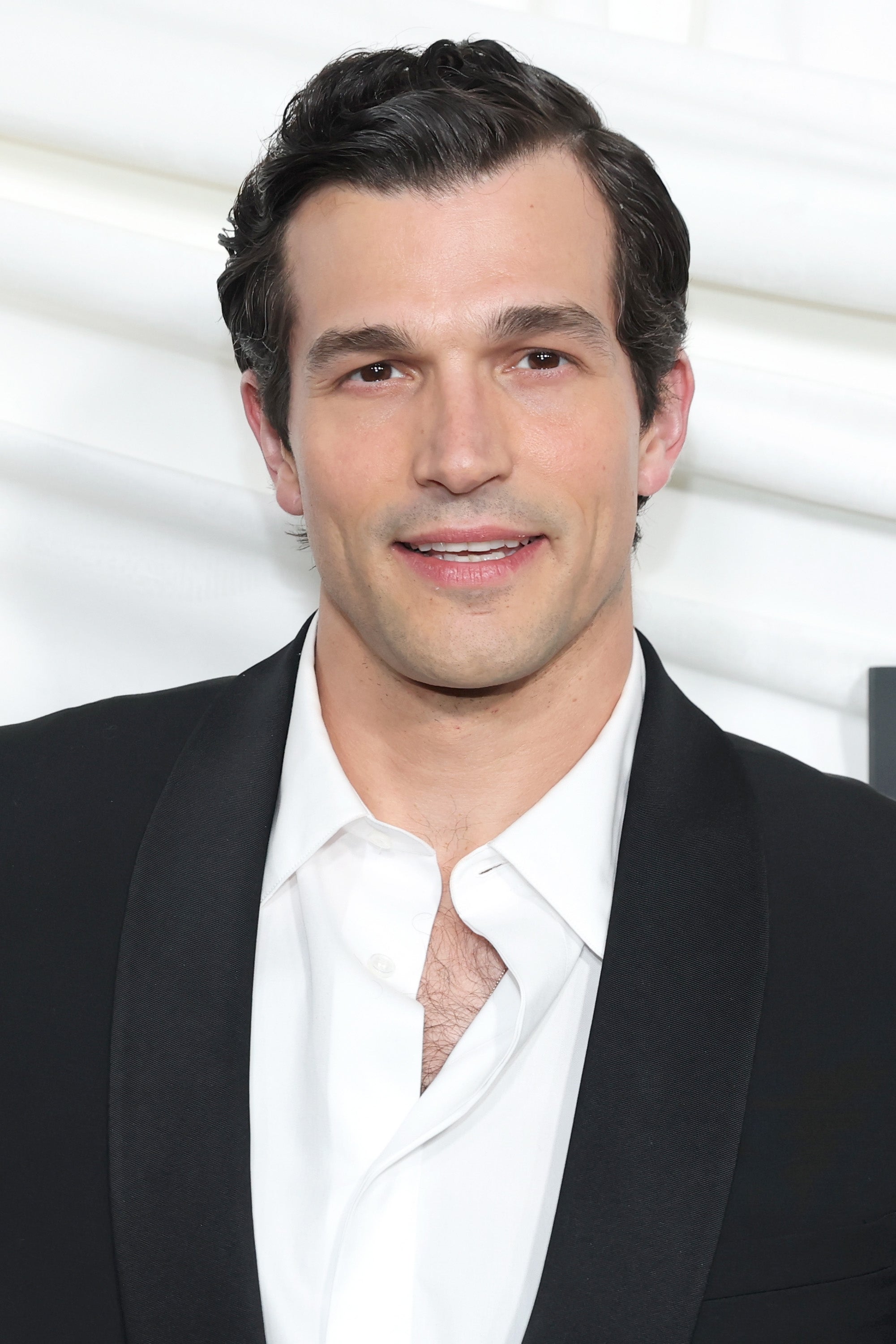 Paul Anthony Kelly wears a suit jacket and white, linen shirt