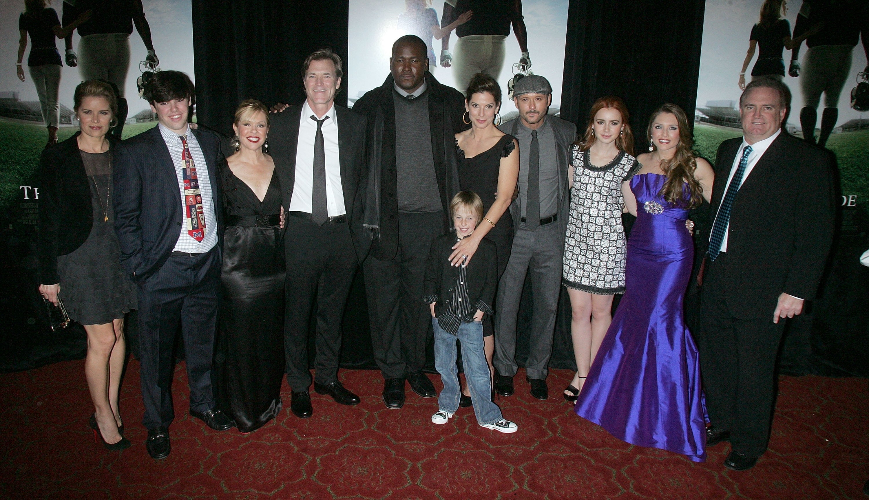The cast of The Blind Side poses at an event with the Tuohy family who the movie is based on