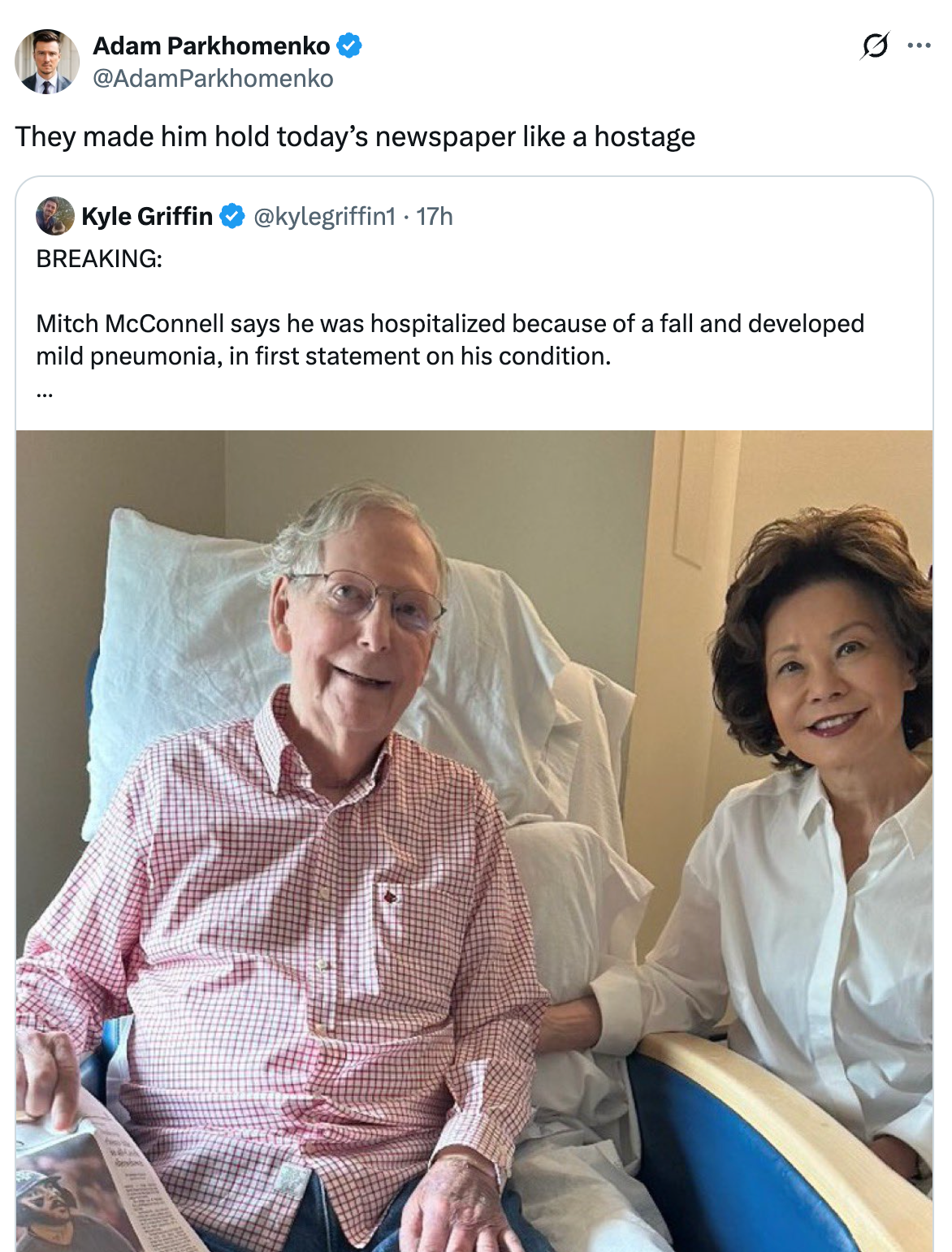 Mitch McConnell sits in a hospital chair, holding a newspaper, next to a woman in a formal setting, as reported on social media