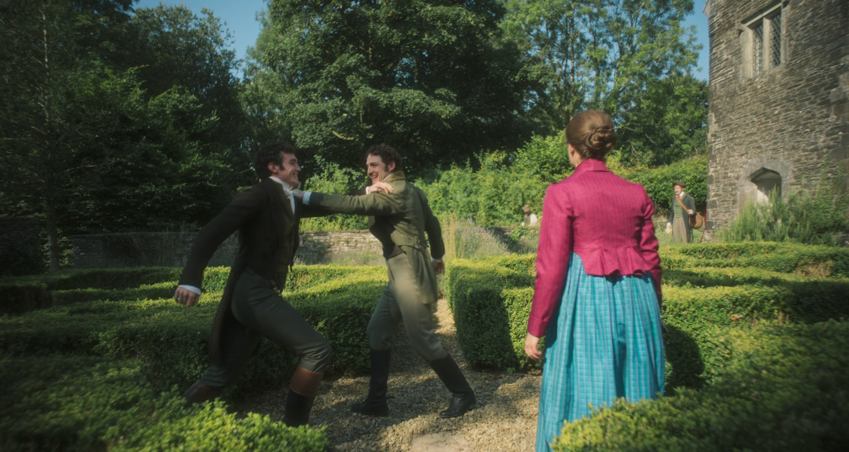 A period scene with two men in vintage suits facing off in a garden maze, watched by a woman in period dress with a pink jacket and blue skirt