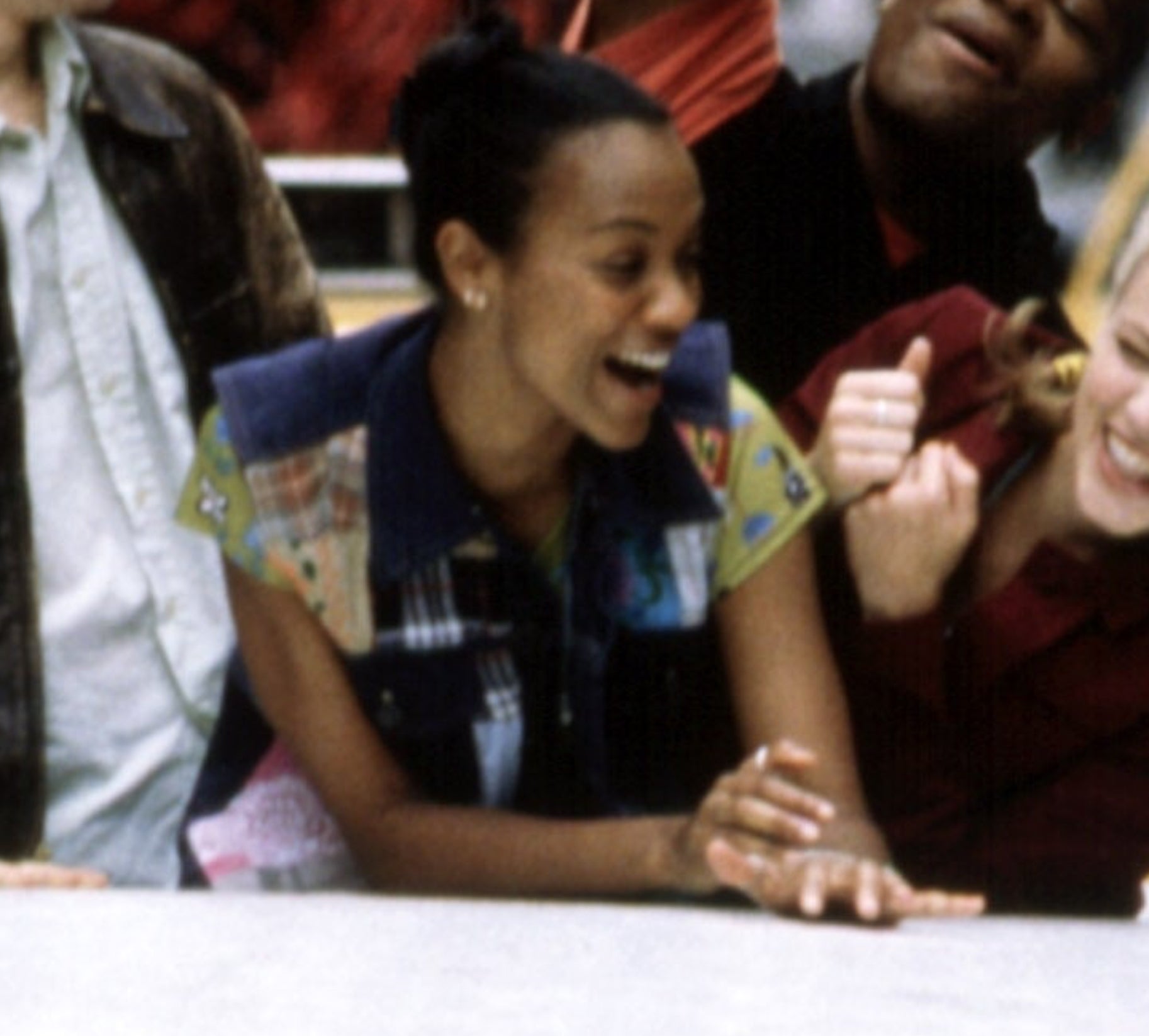 Young Zoe Saldana laughing and enjoying herself in a casual setting