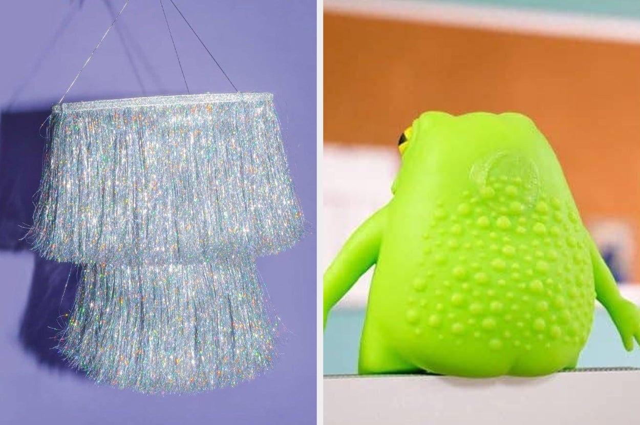 A fringed, shiny lamp on the left and a textured green frog toy from behind on the right