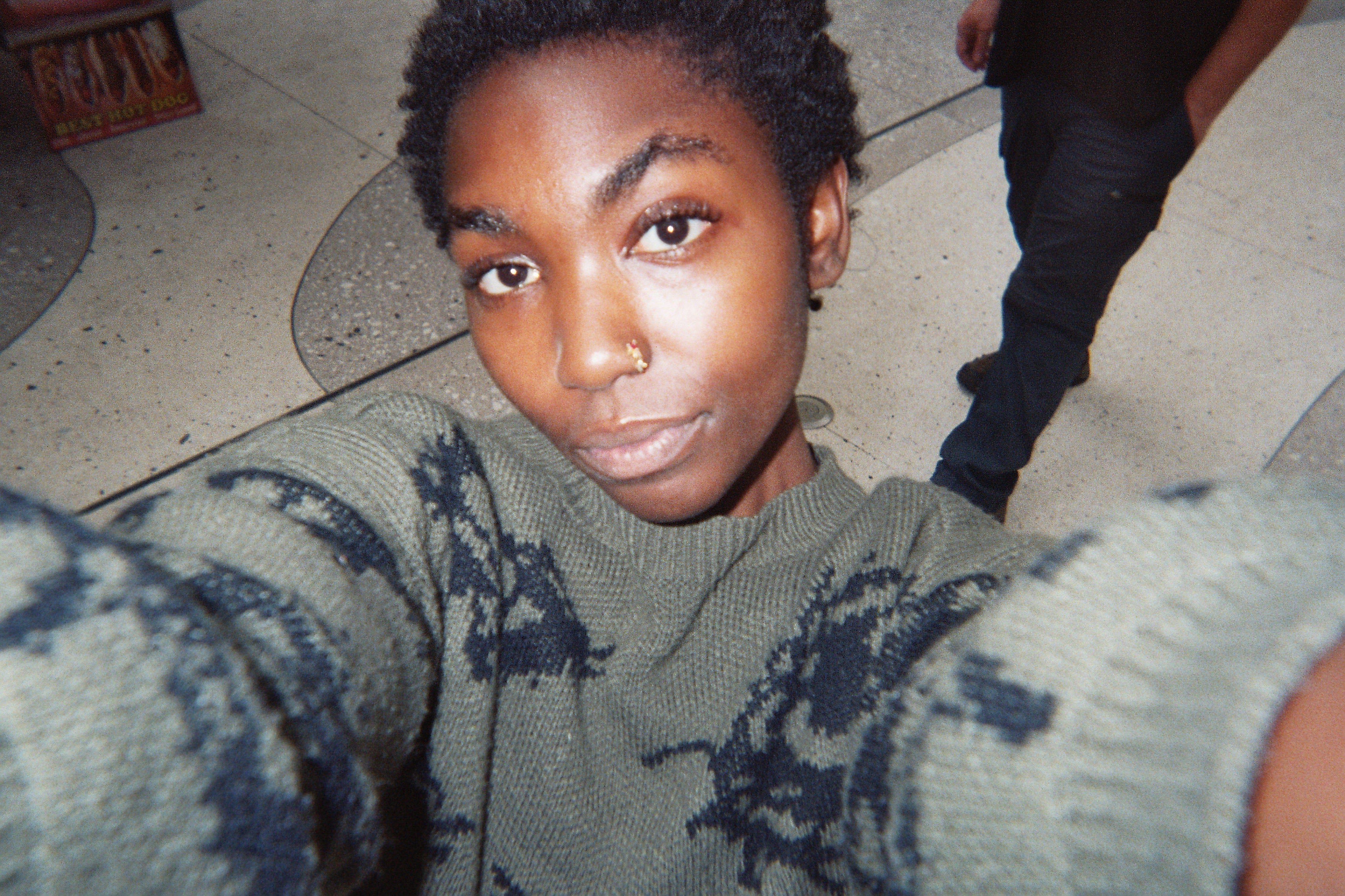 Person taking a selfie successful  a mounting  that appears casual, wearing a patterned sweater