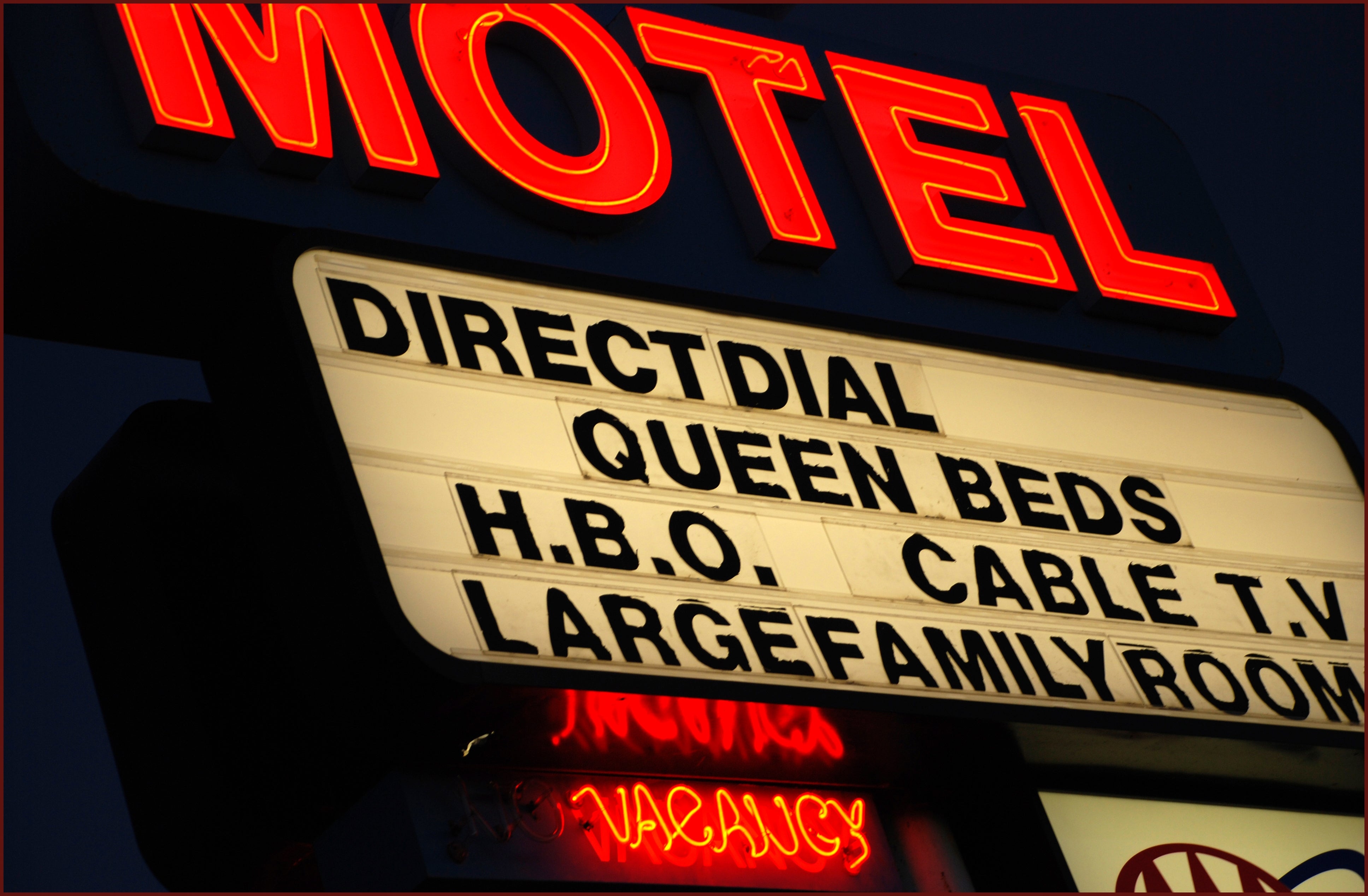 "Direct Dial," "Queen Beds," "H.B.O.," "Cable T.V.," and "Large Family Room." Vacancy motion lit below