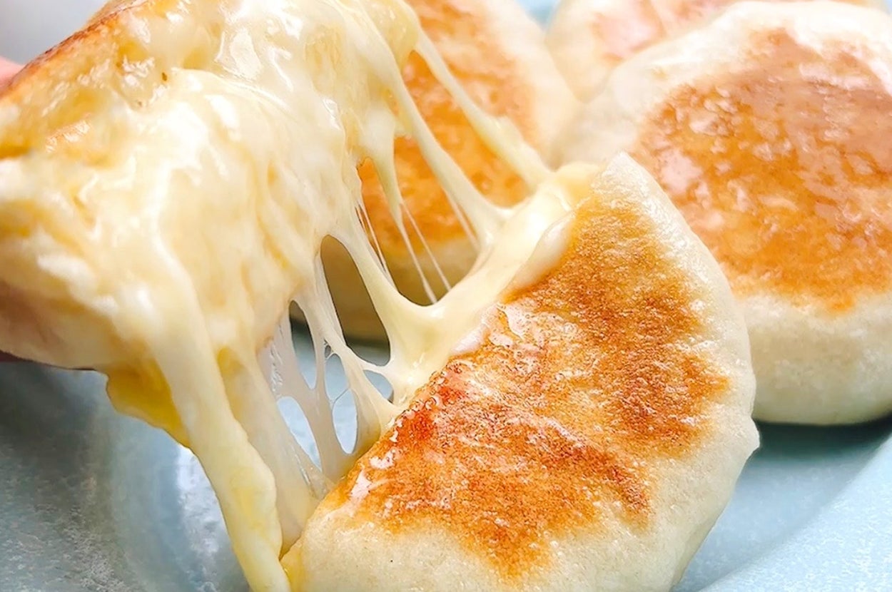 チーズが伸びる焼き餃子がプレートに盛られている。