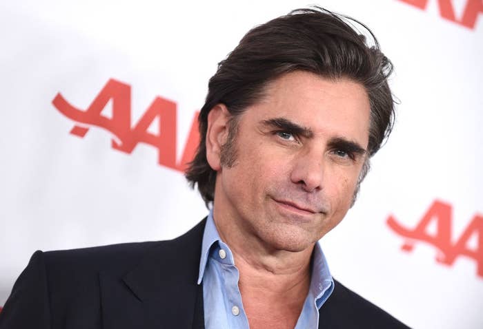 John Stamos posing at an event