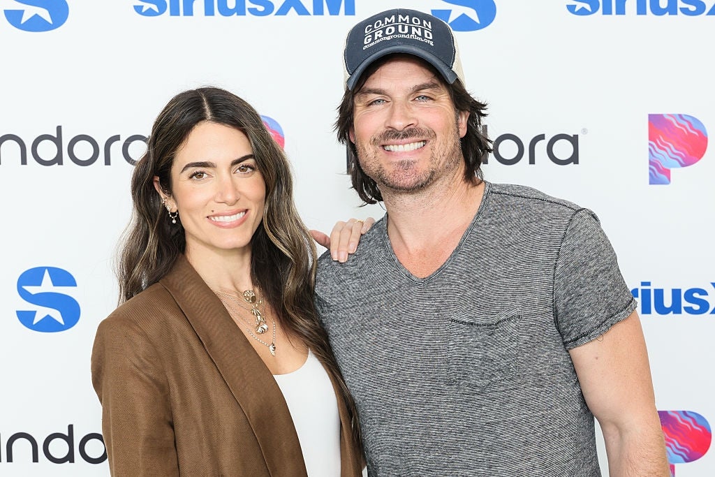 Ian Somerhalder and Nikki Reed are smiling for a photo at an event