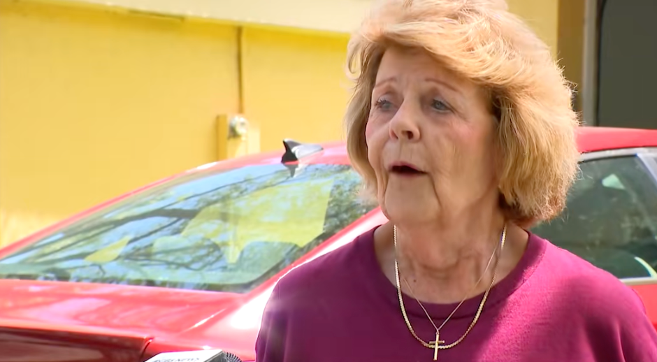 A pistillate stands extracurricular by a car, speaking to idiosyncratic off-camera. She is wearing a transverse necklace