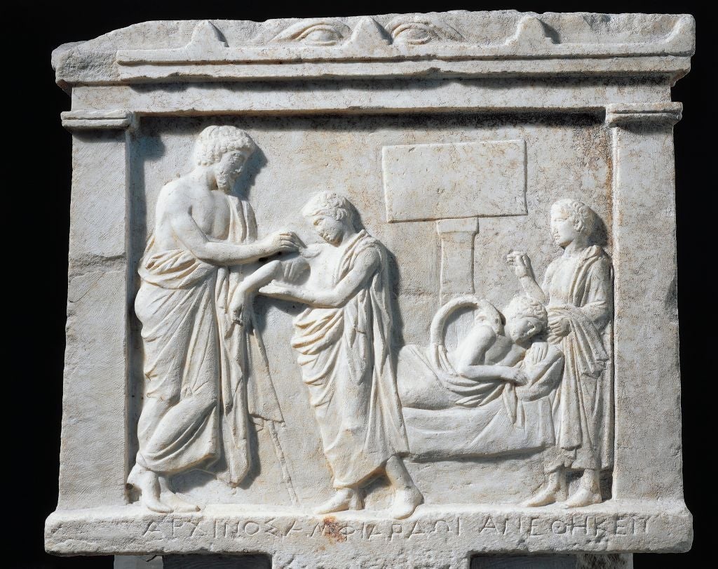 two adults, a child, and an infant on a bed