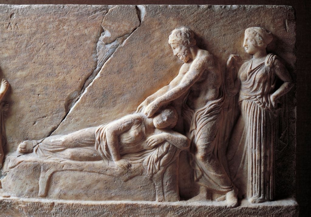 Ancient Greek relief depicting a seated figure being tended to by two standing figures, one offering support and the other observing