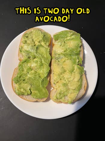 Avocado toast on white bread is served on a white plate against a dark background